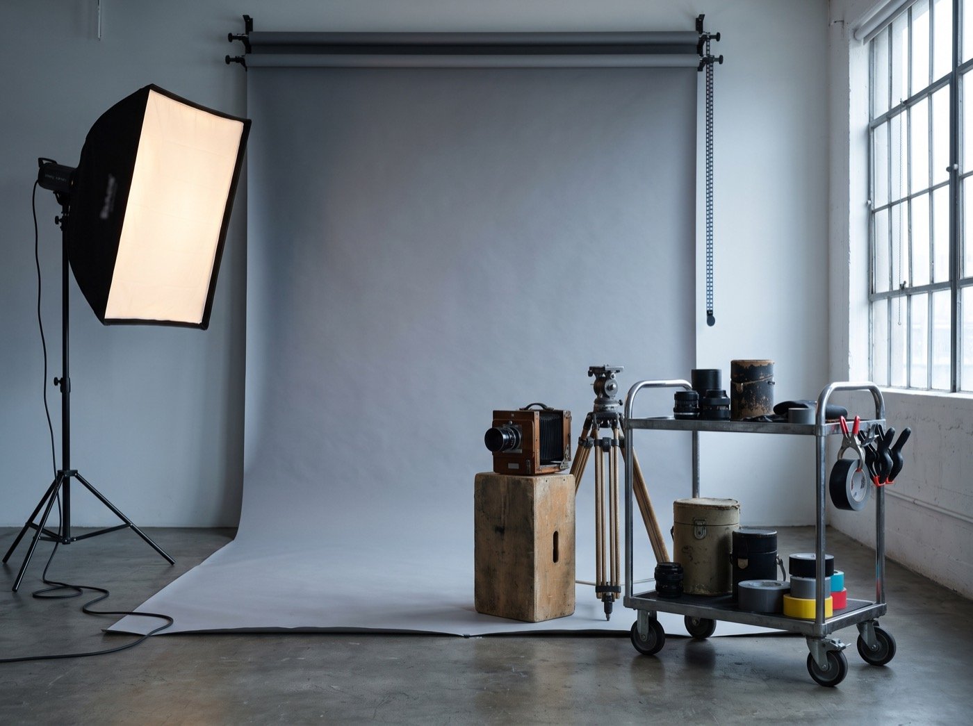 Grey backdrop, softbox and a film camera in a photo studio