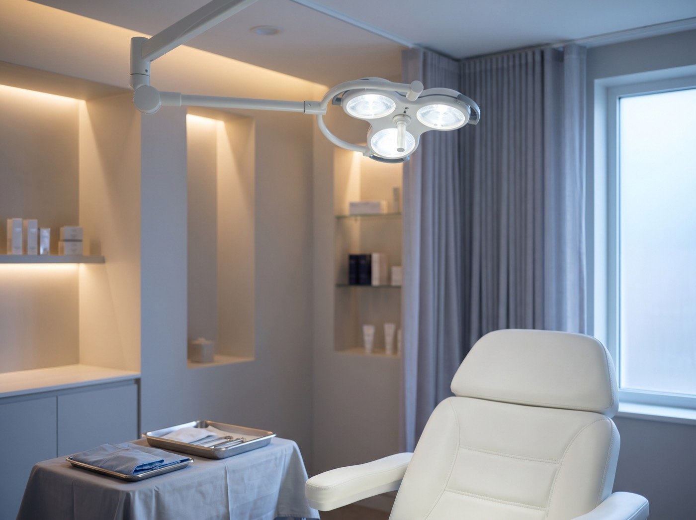 Surgical light above a white reclining chair in a procedure room