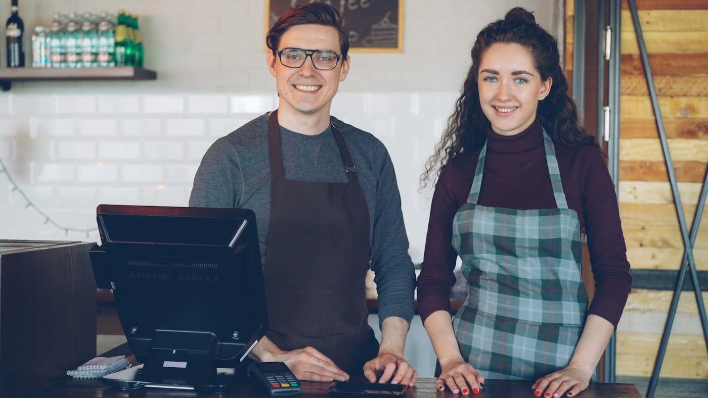Two cafe workers behind the counter of an independent cafe