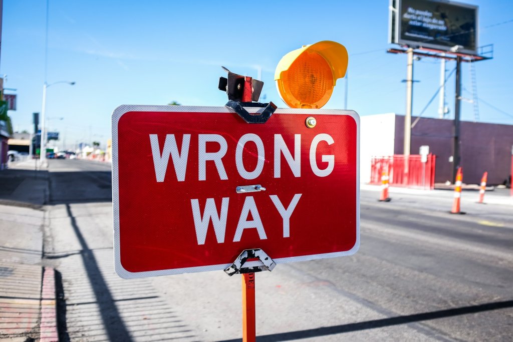 Red "Wrong Way" road sign — symbolizing the path to penalty recovery