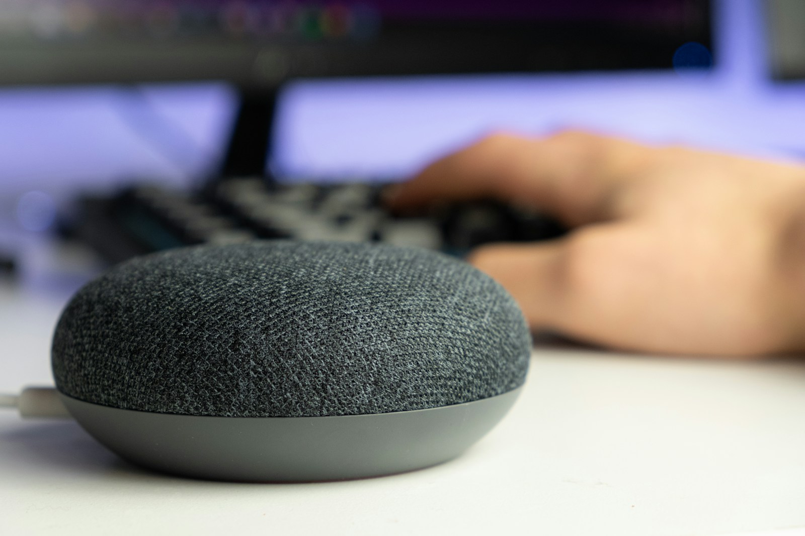 Gray and black portable smart speaker — representing voice search and AEO